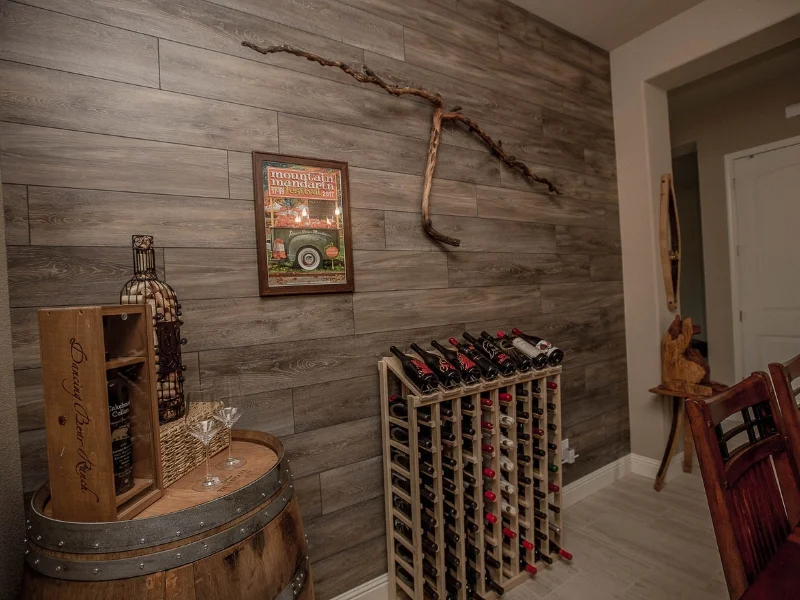 Rustic designed dining area with wine rack and vinyl feature wall | Nielson Fine Floors | Lincoln, CA